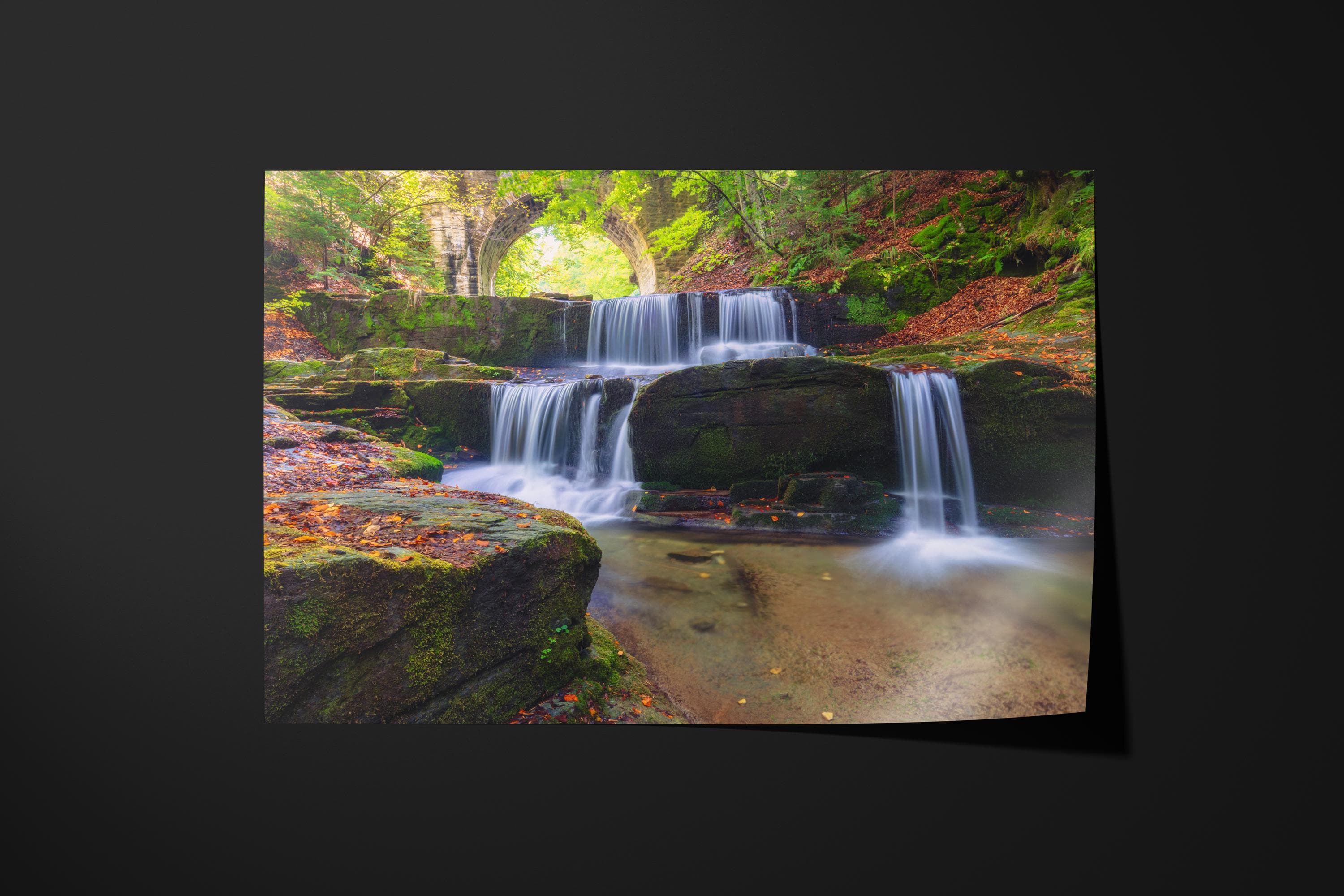 Tranquil Waterfall Under Stone Bridge