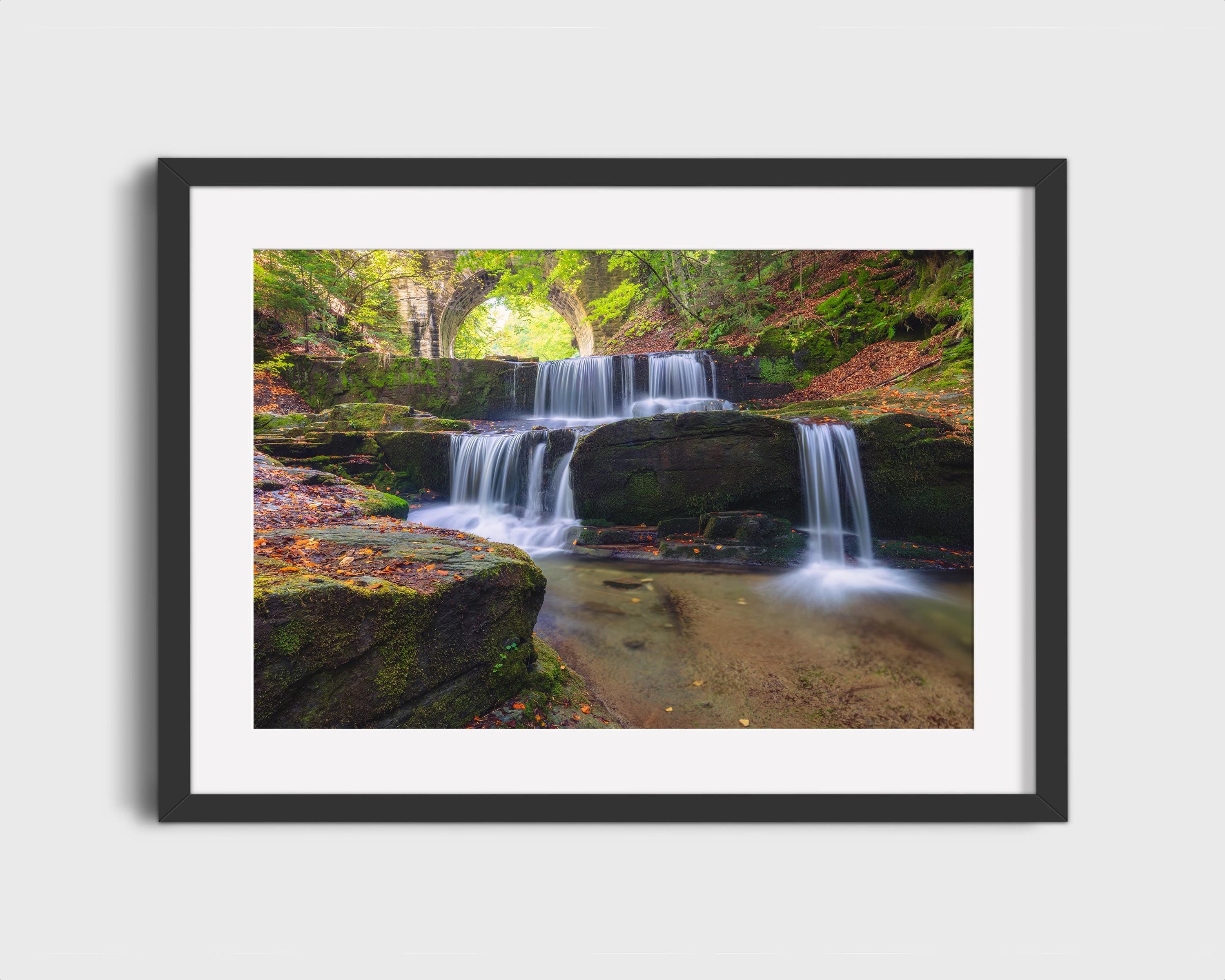 Tranquil Waterfall Under Stone Bridge